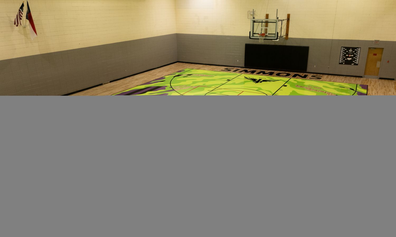 View of a purple and green YMCA basketball court.